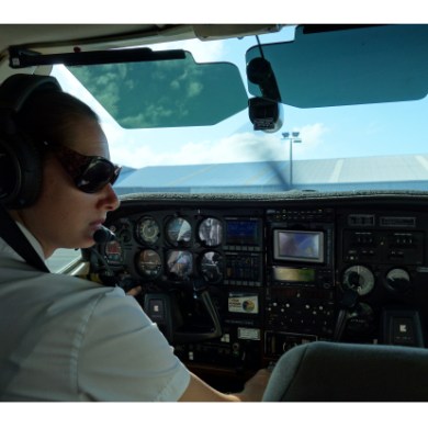 pilot in plane with controls