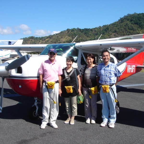 group of people in front of plane